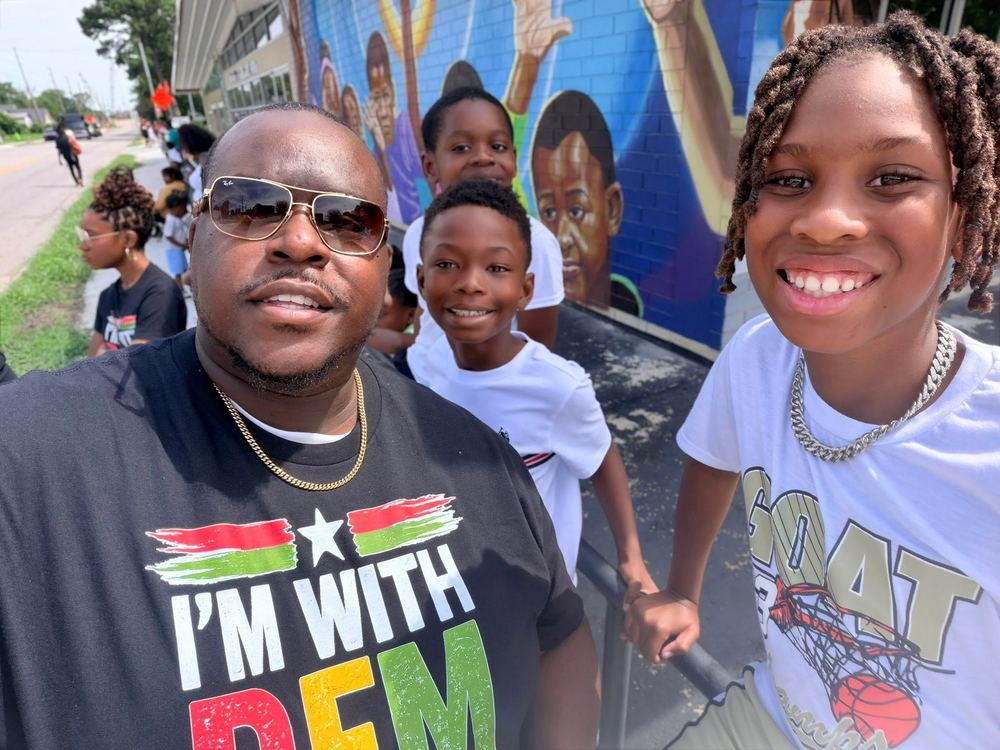 Jessie Cave with students at a community mural event